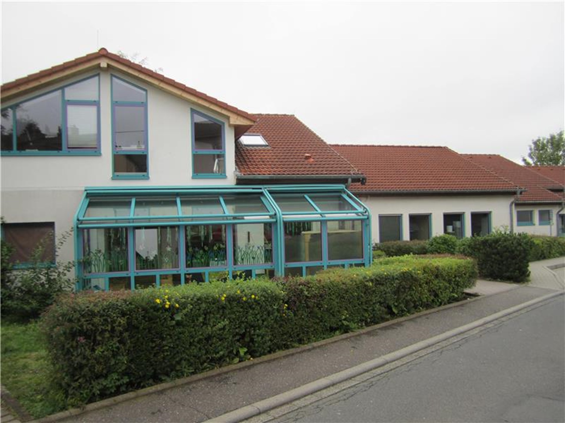 Blick auf das Gebäude der integrativen Kita St. Franziskus in Wirges, mit einem großen Wintergarten.